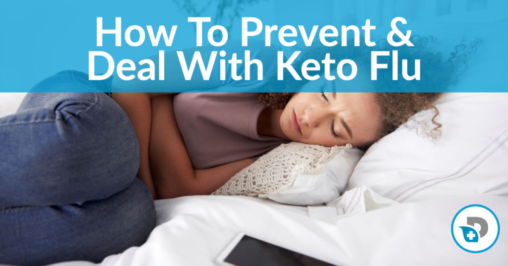 A woman lays in bed suffering from keto flu